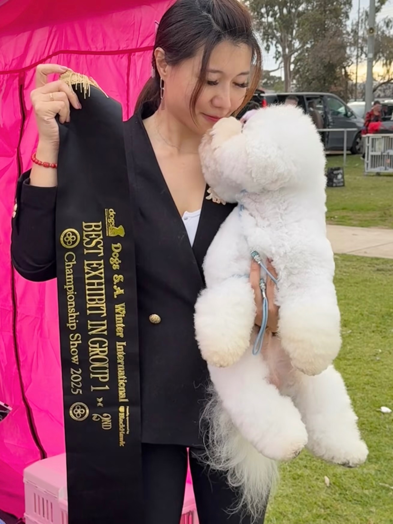 A family enjoying time with their Bichon Frisé